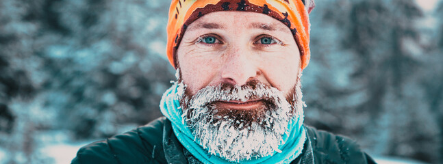 portrait of man face with frozen beard in harsh winter
