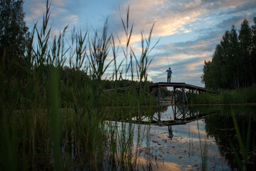 Fishing in the early summer morning, view from the grass