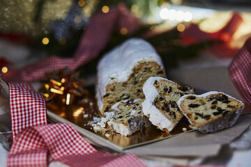 Christmas stollen, known in Germany as Christstollen, is a yeast bread. Christmas tradition with bokeh background. Festive background