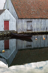 Old wooden boat at the wharf. Skudeneshavn. Concept of travel.  Vertical photo.