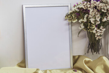 Minimalist mockup wall frame and vase with dried flowers. Place for text or advertising.