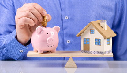 home and piggy bank agent hold gold coin Us dollar sign put on the scales with balance saving or...