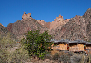 The natural unusual landscape of the Red Canyon of unusual beauty is similar to the Martian landscape of the Charyn Canyon. Reed huts.