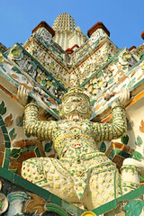 Obraz premium Amazing Architectural Details of the Main Prang of Wat Arun with Mythical Yaksha Demon Sculptures and Pieces of Chinese Porcelain, Bangkok, Thailand 
