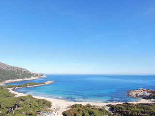 Fototapeta na wymiar Cala Agulla Mallorca. Aerial view of the seacoast of the beach in Mallorca with torquoise water colour. Amazing photo of the beach. Concept of summer, travel, relax and holiday and vacation