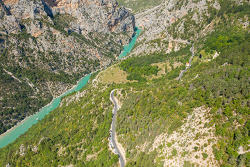 Fototapeta premium A road parallel to the Verdon river surrounded by gorges and mountains in Europe, France, Provence Alpes Cote dAzur, Var, in summer, on a sunny day.
