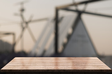 Empty wooden table top with lights bokeh on blur restaurant background.