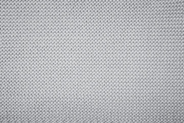Fototapeta na wymiar Knitted wool background. Grey texture knitted wool sweater