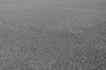 Gray rubber coating made of recycled rubber chips on the sports field. Selective focus