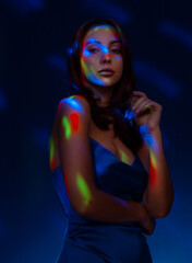 Fototapeta premium Portrait in the style of light painting. Brunette woman in blu dress long exposure photo, abstract portrait light and freezelight background