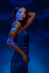Fototapeta na wymiar Portrait in the style of light painting. Brunette woman in blu dress long exposure photo, abstract portrait light and freezelight background
