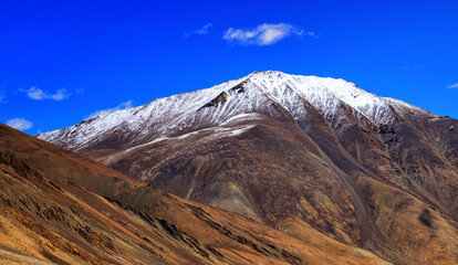 Rocky landscape of with ice peaks in background , Ladakh, Jammu and Kashmir, India
