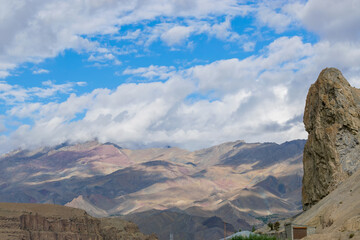 Shadows of clouds on Himalayan mountains at Mulbek, Ladakh. Blue sky with white clouds in the background. - obrazy, fototapety, plakaty