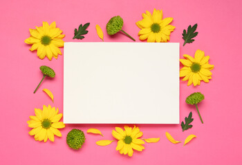 Beautiful chrysanthemums and blank card on pink background, flat lay. Space for text