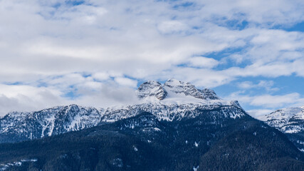 panorama of high mountains covered by snow cloudy blue sky british columbia canada