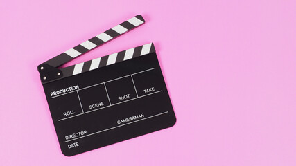 Black Clapper board or movie slate on pink background..