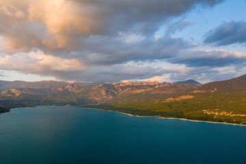 The Lac de Sainte-Croix surrounded by the impressive mountains in Europe, in France, Provence Alpes Cote dAzur, in the Var, in summer, on a sunny day.