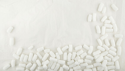 Styrofoam packing peanuts  background. White plastic foam pellets protective for parcel packing.