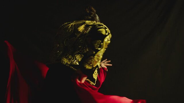 Male dancer or toreador imitating moves of matador bullfighter on black smoky background .  Man bullfighter dressed in bullfighting costume . Shot on ARRI Alexa cinema camera in Slow Motion 