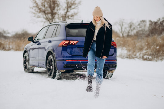 Woman In Winter Cloths Standing By Her Car