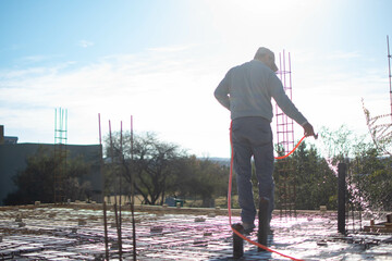 adult man wetting ceiling to be able to be filled with concrete