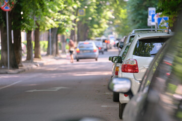 City traffic with cars parked in line on street side