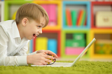 boy playing video game on  laptop