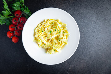 Fettuccine pasta or Tagliatelle creamy parmesan sauce healthy meal food diet snack on the table copy space food background rustic. top view