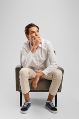 Handsome young man man looks up thoughtfully