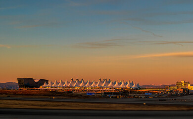 Denver International Airport at dusk against the sunset sky