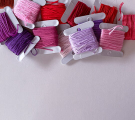 Colorful embroidery threads on white background