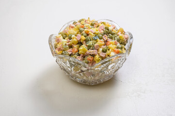crystal salad bowl with traditional New Year's Russian dish - Olivier