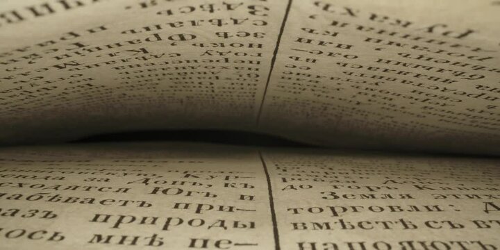 Close-up of the pages of an old book in Russian. Inside the book. Slider movement. 4k