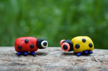 Figurines of two ladybirds made of plasticine.