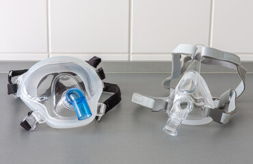 Two types of non-invasive ventilation face mask, close up view, in ICU in hospital.