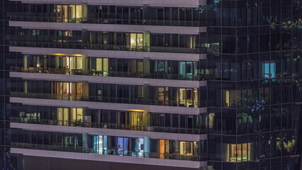 Fototapeta na wymiar Windows lights in modern residential buildings timelapse at night