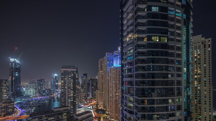 Fototapeta na wymiar Overview to JBR and Dubai Marina skyline with modern high rise skyscrapers waterfront living apartments aerial night timelapse