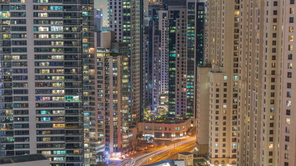 Fototapeta na wymiar Overview to JBR and Dubai Marina skyline with modern high rise skyscrapers waterfront living apartments aerial all night timelapse