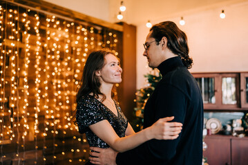 Young happy dancing couple in love at christmas celebrationcelebration