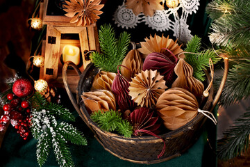 Wicker basket full of DIY paper decors for Christmas