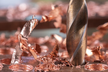 Metal copper drilling with shavings. Close-up of metalwork - obrazy, fototapety, plakaty
