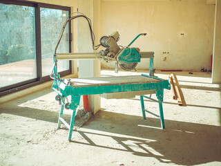 Tiling and laying of marble and porcelain stoneware concept. Wet saw cutting tile machine. Large...