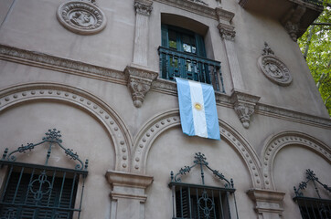 Argentinian flag hangs down vertically from balcony of historic building in Mendoza city. National...