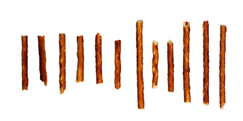 Assorted salted pretzel sticks in a row on a white background