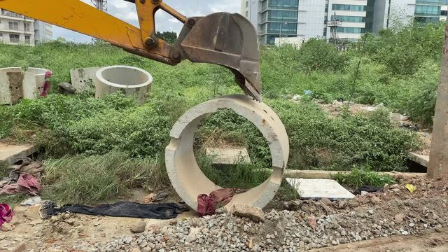 The modern excavator JCB performs excavation work, dump truck at work on a construction site. The process of transporting and unloading stone chips for road repairing   