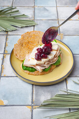 toast with spinach, French cheese Bri ham and jam on tile background