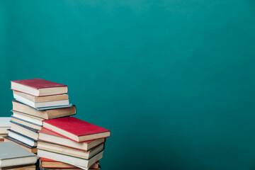 stacks of books for teaching knowledge of the university library green background