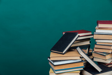 stacks of books for teaching knowledge of the university library green background