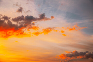 Sunset Cloudy Sky With Fluffy Clouds. Sunset Sky Natural Background. Sunrays, sunray, ray, Dramatic Sky. Sunset In Yellow, Orange, Pink Colors. Summer summertime background