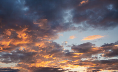 Dramatic orange afternoon sun lit on dark blue sunset sky, nature background